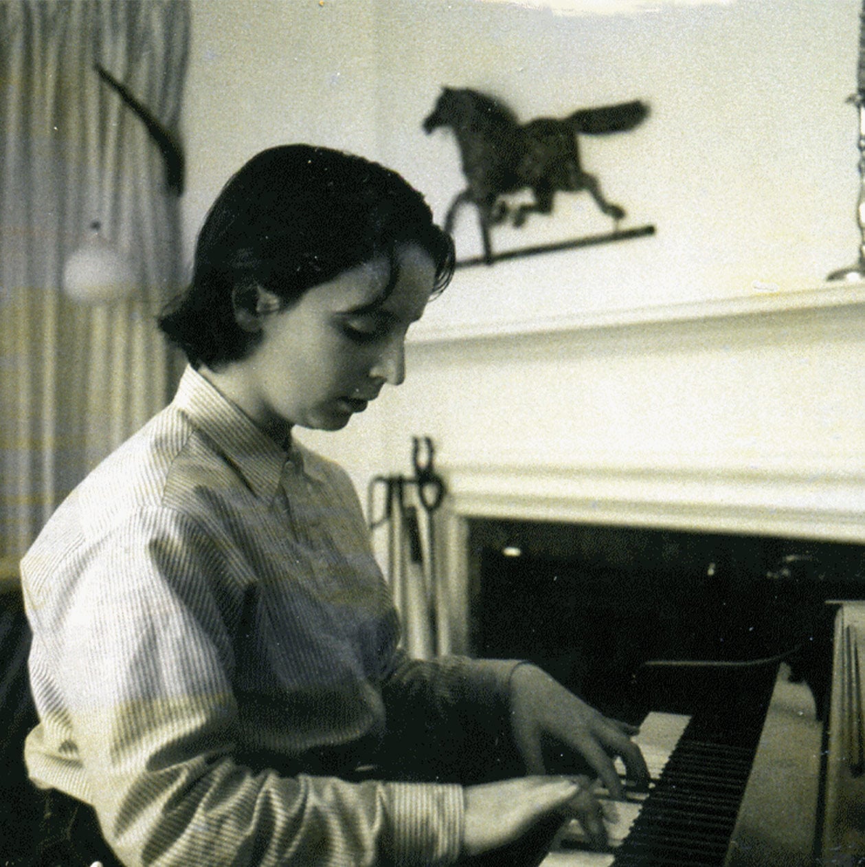 An old photograph of the author playing the piano
